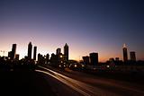 Nightscape of Atlanta, Georgia with blurred lights on highway.