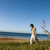 Woman walking on beach.