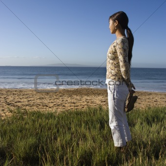 Woman standing on beach.