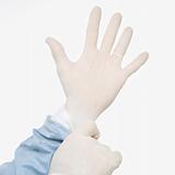 Man putting on latex medical gloves.