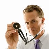 Doctor holding out stethoscope.