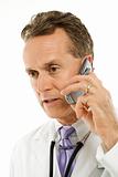 Doctor with talking on cell phone.