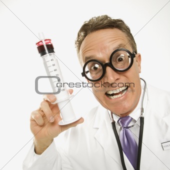 Doctor holding an oversized syringe.