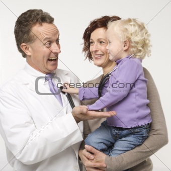 Little girl playing with stethoscope.