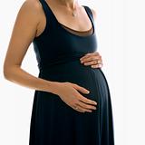 Pregnant woman with hands on belly.