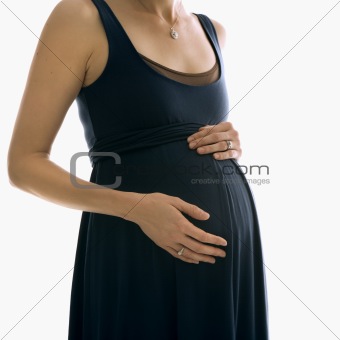 Pregnant woman with hands on belly.