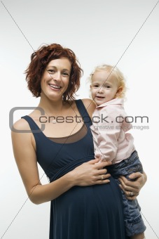 Pregnant woman holding child.