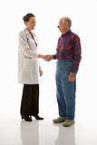 Doctor shaking hands with an elderly man.