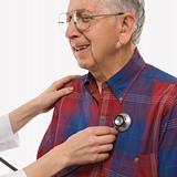 Female hands listening  to elderly man's heart with stethoscope.