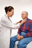 Doctor checking an elderly man's pulse.