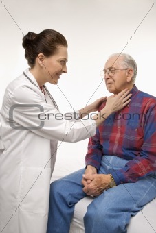 Doctor checking an elderly man's pulse.