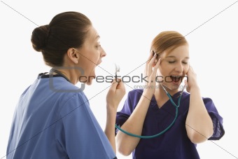 Caucasian women medical healthcare workers playing with stethosc
