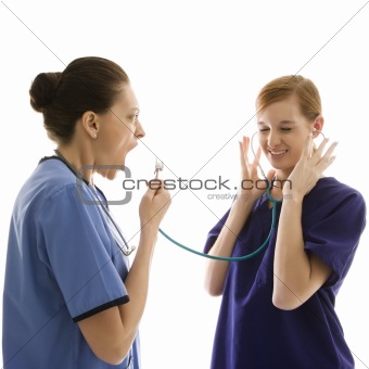 Caucasian women medical healthcare workers playing with stethosc