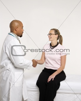 Doctor and patient shaking hands.