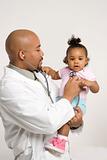Male pediatrician examining baby girl.