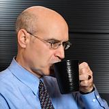Caucasian businessman drinking coffee.