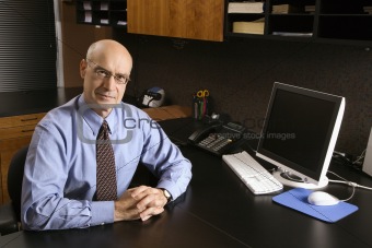 Caucasian businessman at desk.