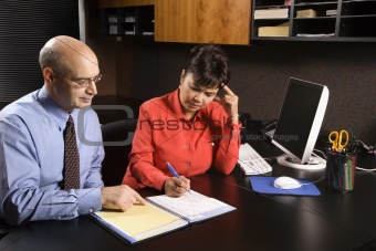Businessman and businesswoman in office.