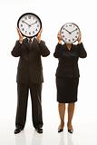 Businesspeople holding clocks.