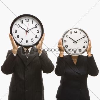 Businesspeople holding clocks.