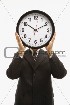 Businessman holding clock.ackground.