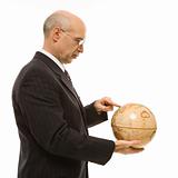 Businessman holding globe.