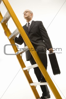 Businessman climbing ladder.