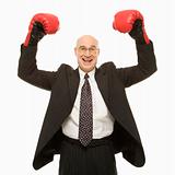 Businessman wearing boxing gloves.