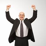 Businessman jumping with arms raised.