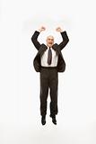 Businessman jumping with arms raised.