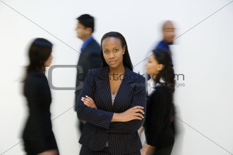 Businesswoman portrait with others. walking by.
