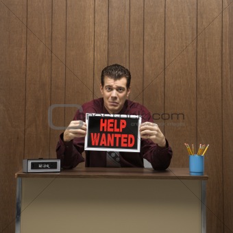 Retro businessman holding help wanted sign.