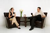 Man and woman sitting drinking coffee.