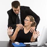 Man harassing woman at computer.