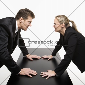 Man and woman staring at each other with hostile expressions.