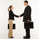 Businessman and woman shaking hands.