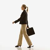 Businesswoman walking with briefcase.