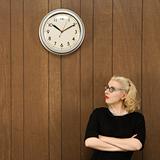 Woman looking up at clock.
