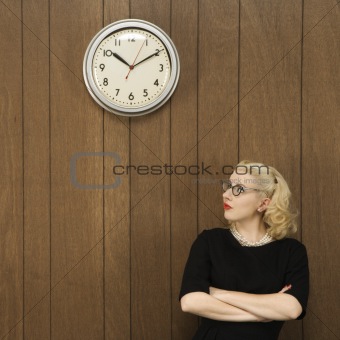 Woman looking up at clock.