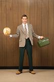 Man in retro suit holding luggage and a globe.
