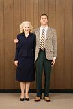 Man in retro suit with arm around woman.