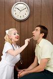 Female nurse examinating man's mouth.