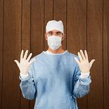 Male surgeon wearing mask and gloves.