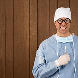 Male surgeon smiling maniacallly holding scalpel.