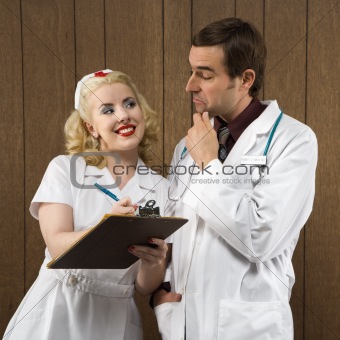 Nurse smiling at doctor.