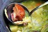 Pig-iron saucepan with soup