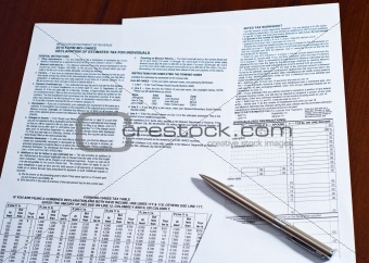 Tax form with pen on a desk.