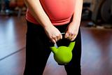 Pregnant woman exercising with a kettlebell