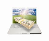 Silver Computer Laptop Isolated on White with Stacks of Hundred Dollar Bills Extruding the Screen.