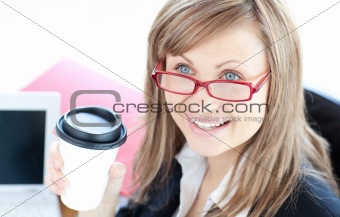 Bright businesswoman drinking coffee 